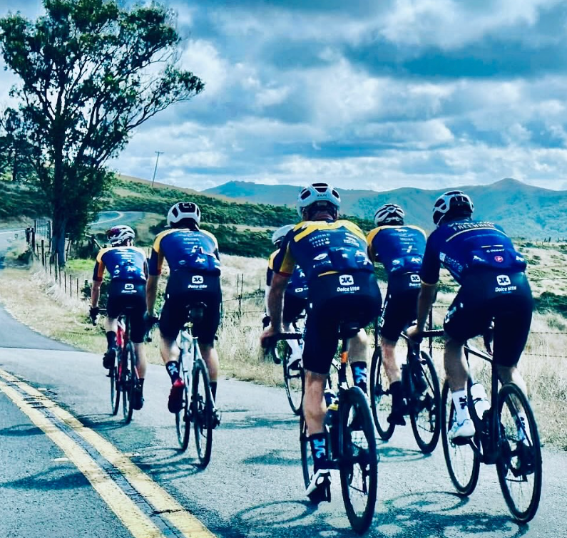 Group of cyclists on a road with a scenic background